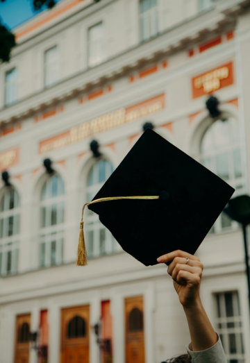 person holding black academic hat